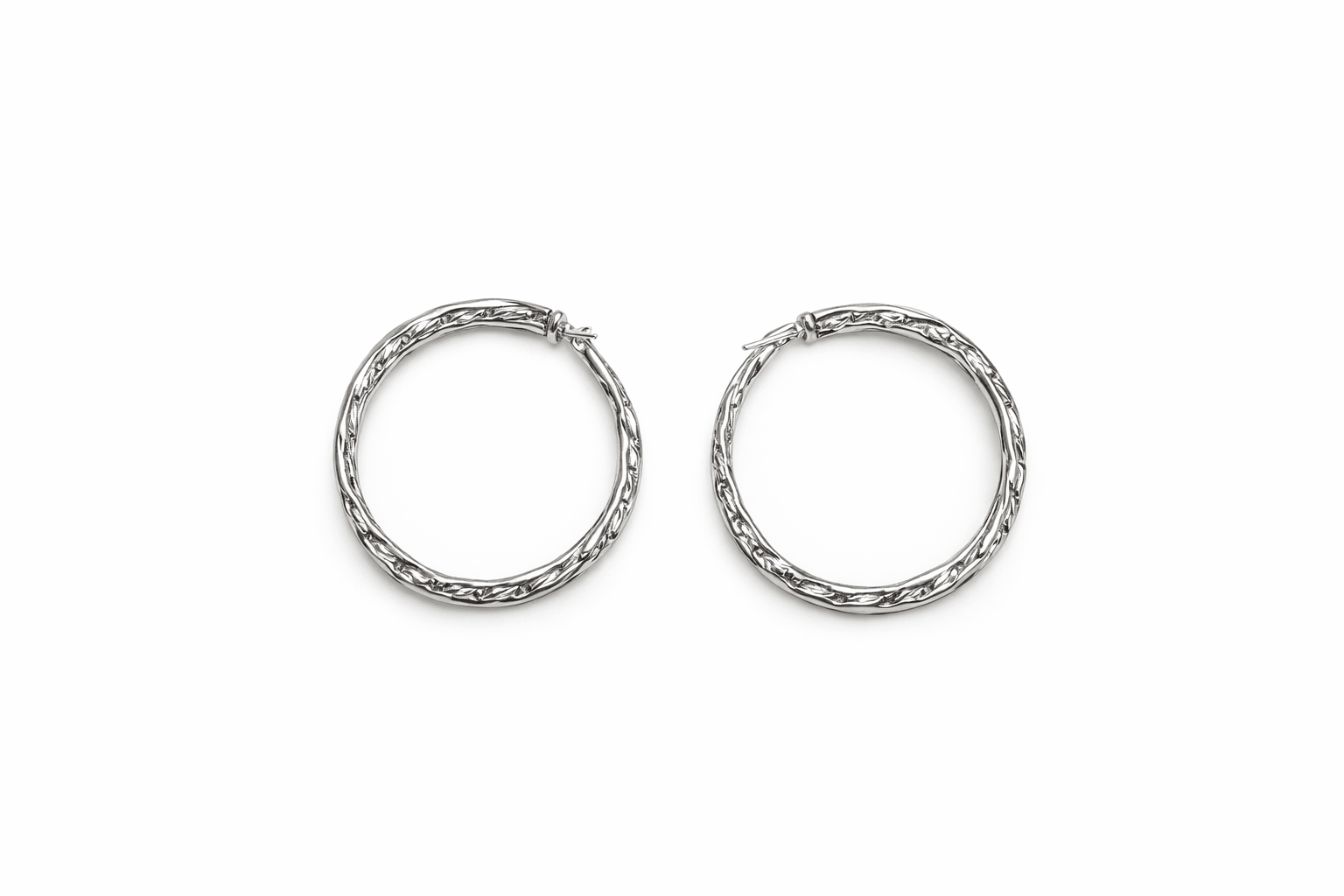 A pair of silver hoop earrings on a white background.