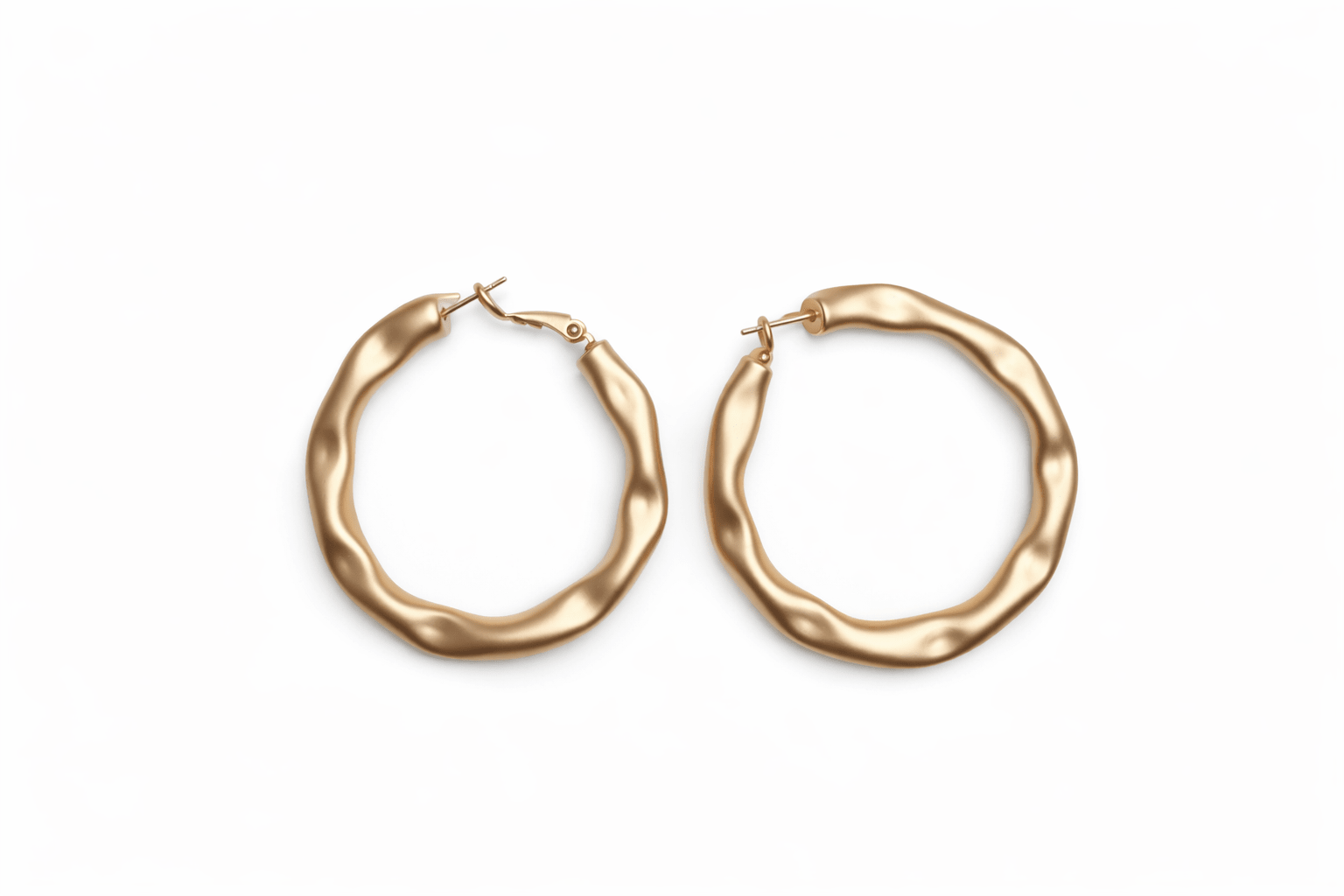 A pair of gold hoop earrings on a white background