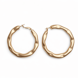 A pair of gold hoop earrings on a white background