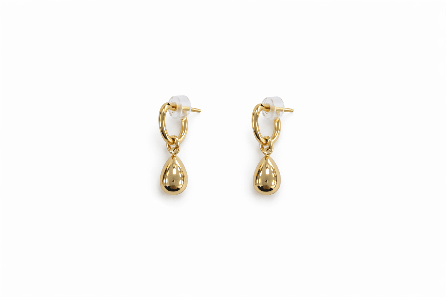 A pair of gold teardrop earrings on a white background