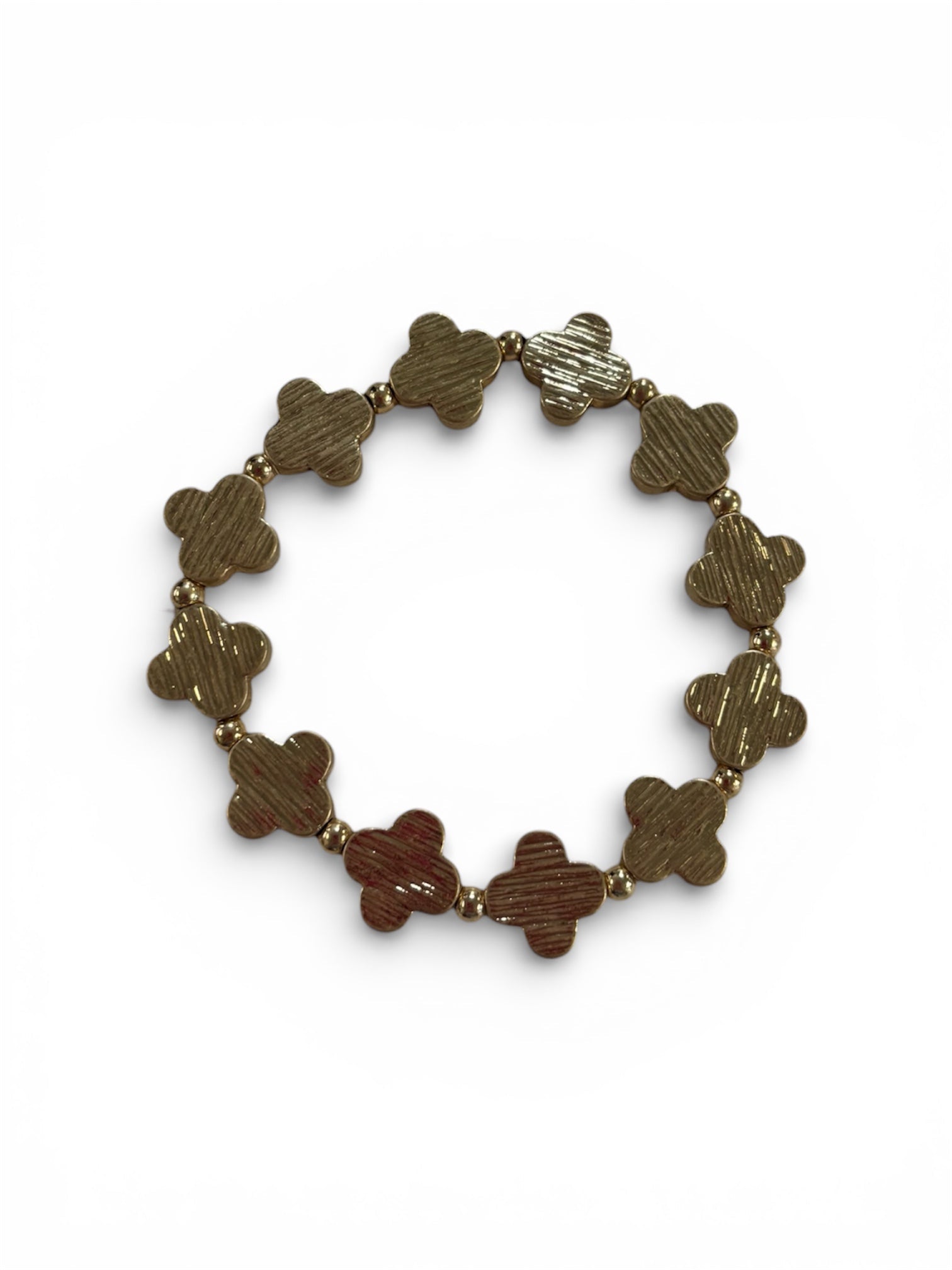 Gold bracelet with clover-shaped links on a white background