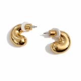 A pair of small gold hoop earrings with white centers on a white background.