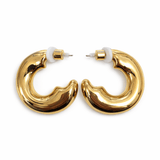 Gold hoop earrings on a white background