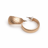 Gold hoop earrings on a white background.