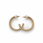 A pair of golden pearl hoops on a white background.