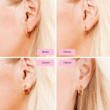 Gold hoop earrings displayed on a person's ear with size labels.
