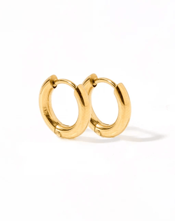 Gold hoop earrings on a white background