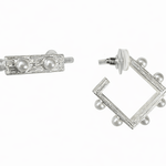 Pair of silver earrings with pearl accents on a white background