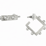 Pair of silver earrings with pearl accents on a white background