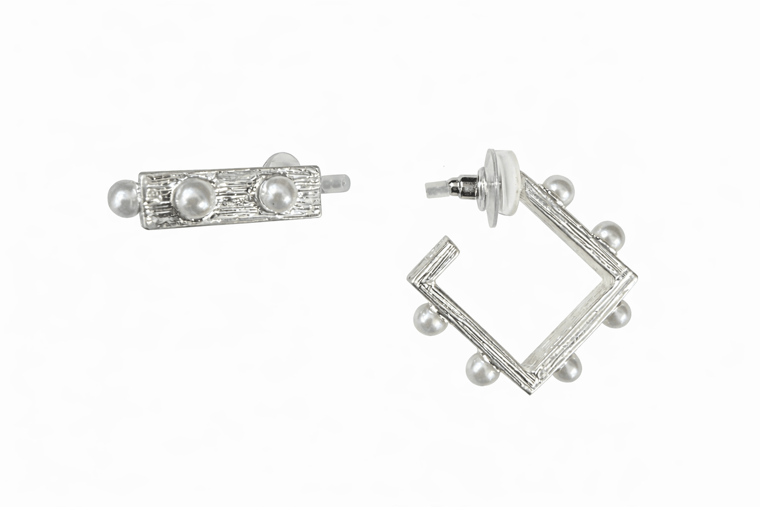 Pair of silver earrings with pearl accents on a white background
