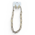 Necklace and earrings set on a white background