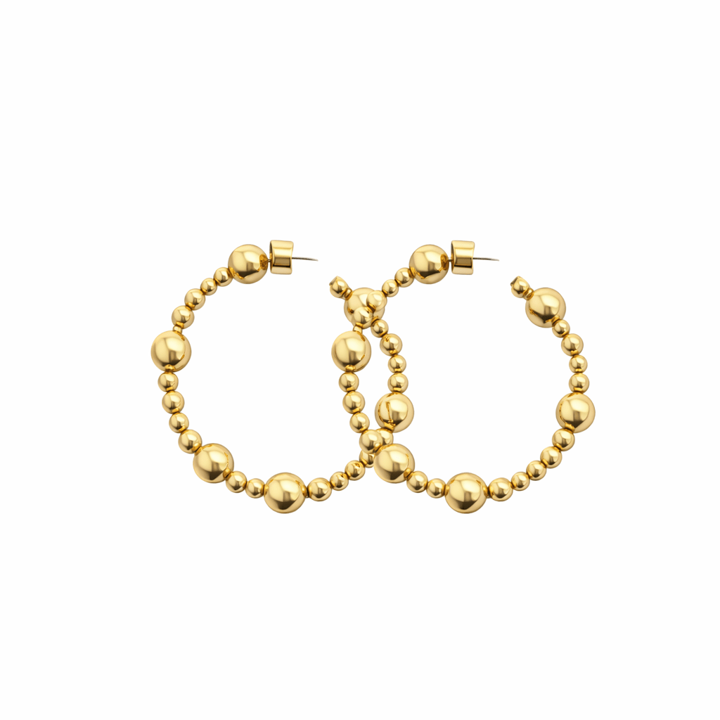 Gold hoop earrings with bead detailing on a white background
