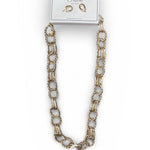 Gold chain necklace on a white background with a card displaying earrings.