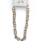 Gold chain necklace on a white background with a card displaying earrings.